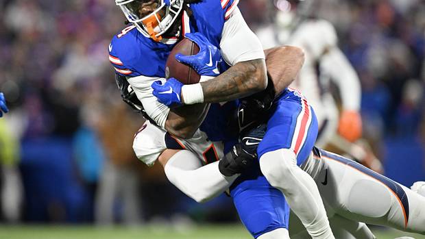 Buffalo Bills running back James Cook gets tackled against the Denver Broncos.