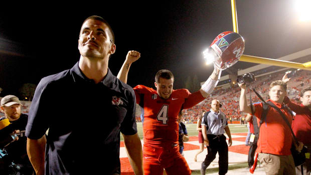 Sep 20, 2013; Fresno, CA, USA; NFL former quarterback David Carr (left) walks off the field next to his brother, Fresno State Bulldogs quarterback Derek Carr (4) after the Bulldogs defeated the Boise State Broncos 41-40 at Bulldog Stadium.