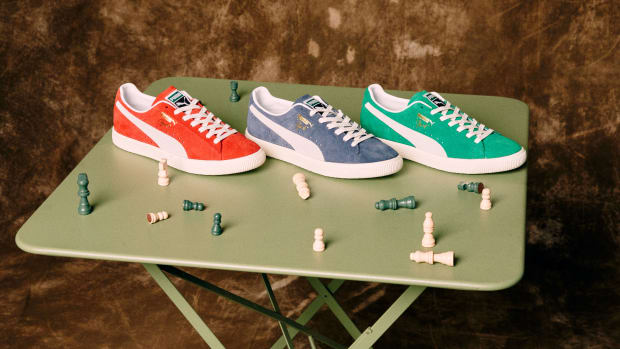 View of red, blue, and green Puma shoes on a table.