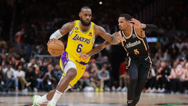 Hawks guard Dejounte Murray defends Lakers forward LeBron James.