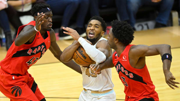 Cleveland Cavaliers guard Donovan Mitchell (45) drives between Toronto Raptors forward Pascal Siakam (43) and forward O.G. Anunoby (3) in the fourth quarter at Rocket Mortgage FieldHouse.