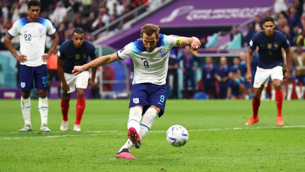 Harry Kane pictured converting a penalty kick against France at the 2022 World Cup to score his 53rd goal for England
