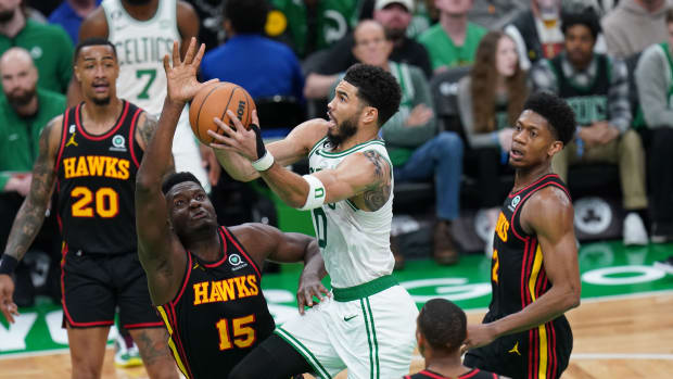 Boston Celtics forward Jayson Tatum shoots a layup over Atlanta Hawks center Clint Capela.