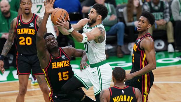 Boston Celtics forward Jayson Tatum shoots a layup over Atlanta Hawks center Clint Capela.