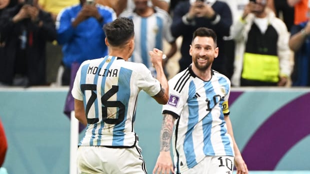 Lionel Messi pictured (right) celebrating with Nahuel Molina after an Argentina goal against Holland at the 2022 World Cup