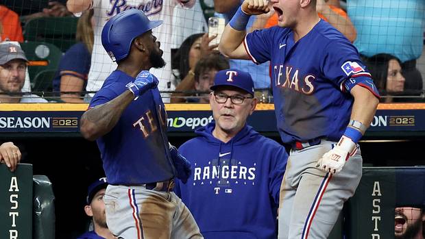 Adolis Garcia, left, celebrates with Josh Jung after hitting a home run in the third inning of Game 7 of the ALCS Monday night at Minute Maid Park in Houston. The Texas Rangers beat the Houston Astros to advance to their first World Series since 2011.