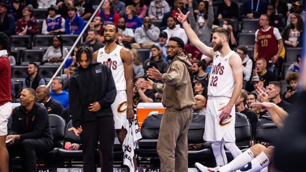Cleveland Cavaliers guard Darius Garland (10), forward Evan Mobley (4), guard Donovan Mitchell (45) and forward Dean Wade (32) celebrate a made 3-pointer by Cleveland Cavaliers forward Kevin Love (not pictured) against the Detroit Pistons in the second quarter at Little Caesars Arena.