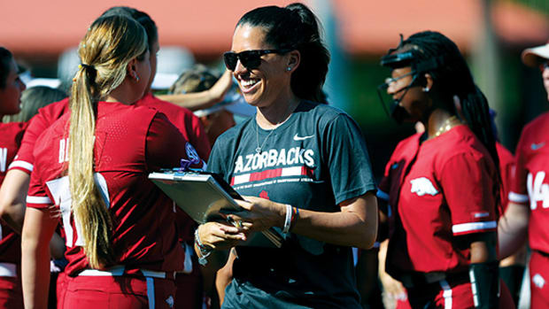 Arkansas softball coach Courtney Deifel heads over for her postgame interview with ESPN following the Razorbacks' 4-0 shutout of Missouri in the SEC Tournament championship game. Deifel is the first coach in Arkansas history to have an overall winning record at 225-125.