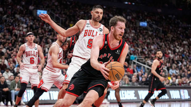 Apr 12, 2023; Toronto, Ontario, CAN; Toronto Raptors center Jakob Poeltl (19) recovers a loose ball against Chicago Bulls center Nikola Vucevic (9) during the second half of a NBA Play-In game at Scotiabank Arena.