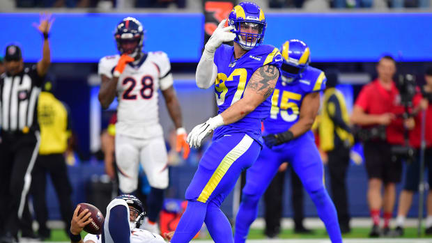 Dec 25, 2022; Inglewood, California, USA; Los Angeles Rams defensive tackle Michael Hoecht (97) reacts after sacking Denver Broncos quarterback Russell Wilson (3) during the second half at SoFi Stadium. Mandatory Credit: Gary A. Vasquez-USA TODAY Sports