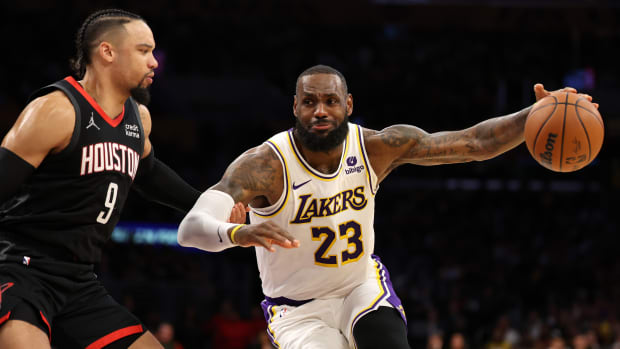 Lakers forward LeBron James (23) dribbles against Houston Rockets forward Dillon Brooks (9) during the second quarter at Crypto.com Arena.