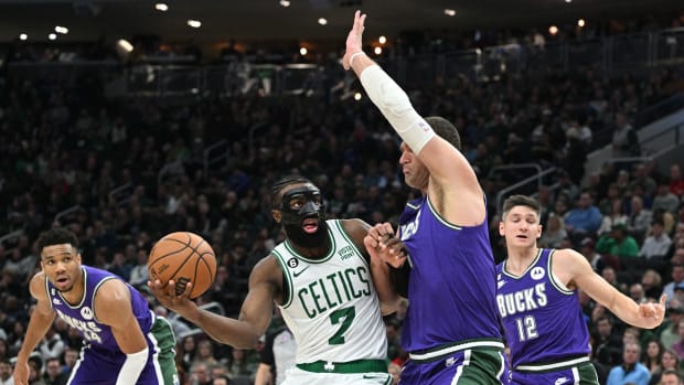 Mar 30, 2023; Milwaukee, Wisconsin, USA; Boston Celtics guard Jaylen Brown (7) drives to the basket against Milwaukee Bucks center Brook Lopez (11)