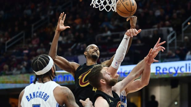 Dec 6, 2023; Cleveland, Ohio, USA; Cleveland Cavaliers forward Evan Mobley (4) and forward Dean Wade (32) go for a rebound against Orlando Magic center Moritz Wagner (21) and forward Paolo Banchero (5) during the second half at Rocket Mortgage FieldHouse.
