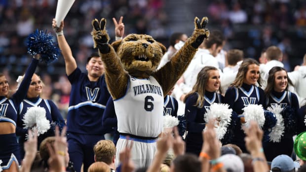Villanova Wildcats cheerleaders and mascot celebrate during a basketball game.