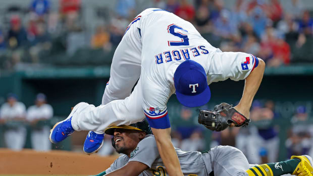 Aug 16, 2022; Arlington, Texas, USA; Oakland Athletics left fielder Tony Kemp (5) slides safely into third base ahead of the tag by Texas Rangers shortstop Corey Seager (5) during the first inning at Globe Life Field. Mandatory Credit: Kevin Jairaj-USA TODAY Sports