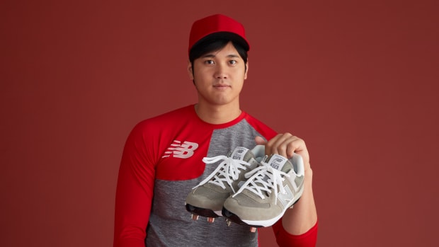 Shohei Ohtani holding cleats.