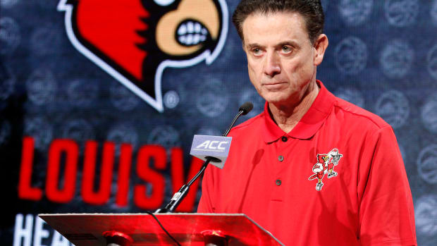 Rick Pitino listens to a question at a press conference.