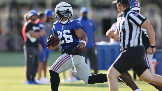 New York Giants running back Saquon Barkley carries the ball during practice.