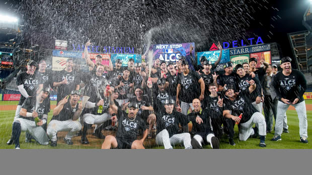 Yankees pose for a photo and pop champagne after beating the Guardians in the ALDS.