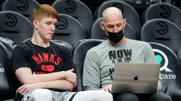 Atlanta Hawks guard Kevin Huerter (3) (left) talks with assistant coach Chris Jent center prior to the game against the Minnesota Timberwolves at State Farm Arena.