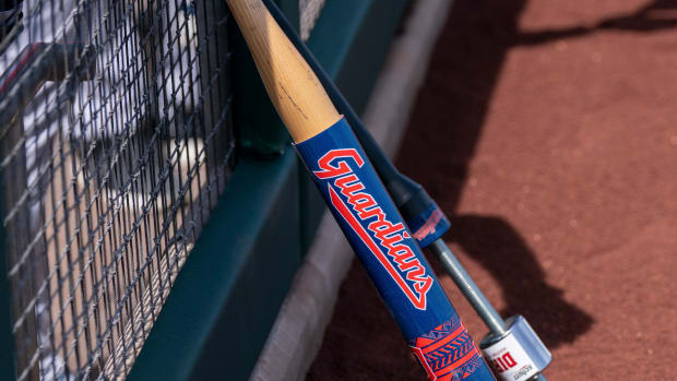 Mar 25, 2022; Scottsdale, Arizona, USA; A warm-up bat with the new branding for the Cleveland Guardians rests on the dugout fencing during spring training against the San Francisco Giants at Scottsdale Stadium. Mandatory Credit: Allan Henry-USA TODAY Sports