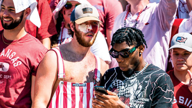 Josh Teeter, a social media personality who attends the University of Arkansas, looks on at a Razorback football game.