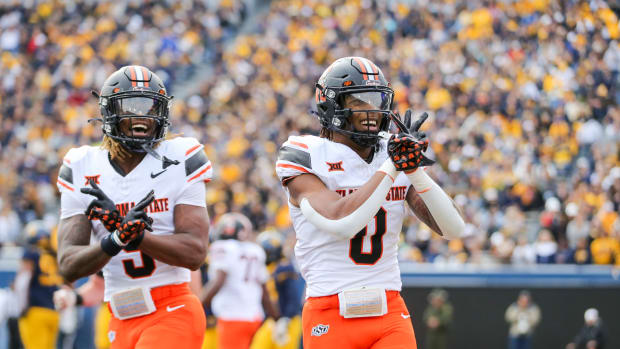 Oct 21, 2023; Morgantown, West Virginia, USA; Oklahoma State Cowboys running back Ollie Gordon II (0) celebrates after running for a touchdown during the first quarter against the West Virginia Mountaineers at Mountaineer Field at Milan Puskar Stadium. Mandatory Credit: Ben Queen-USA TODAY Sports