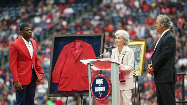 Texans former player Andre Johnson, chairman and chief operating officer D. Cal McNair look on as senior chair Janice McNair (middle) addresses the crowd at NRG Stadium.