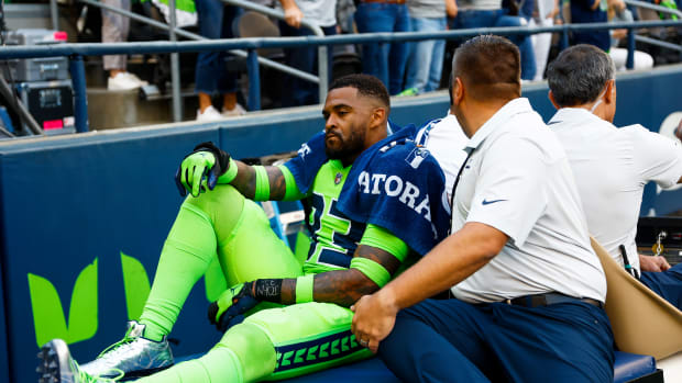Seattle Seahawks safety Jamal Adams (33) is carted off during the second quarter following an injury against the Denver Broncos at Lumen Field.
