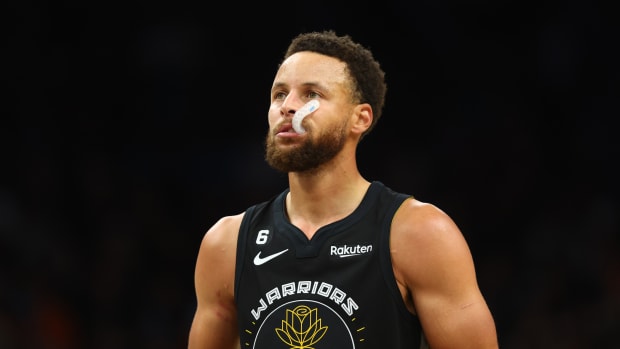 Golden State Warriors guard Stephen Curry chews on his mouth guard during a game.