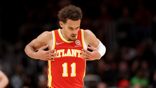 Trae Young reacts after making a shot.
