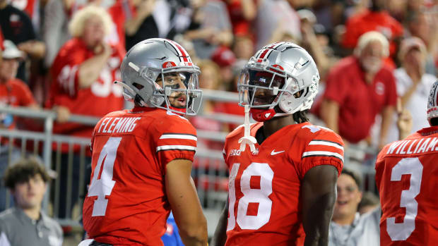 Ohio State wide receivers Julian Fleming (No. 4) and Marvin Harrison Jr. (No. 18) celebrate a touchdown against Toledo.