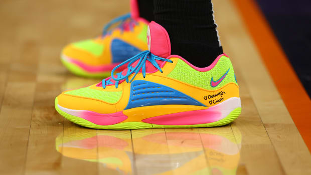 Brooklyn Nets forward Royce O'Neale's yellow and blue Nike KD sneakers.