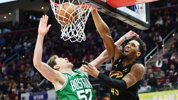 Mar 6, 2023; Cleveland, Ohio, USA; Cleveland Cavaliers guard Donovan Mitchell (45) dunks over Boston Celtics center Mike Muscala (57) during overtime at Rocket Mortgage FieldHouse. Mandatory Credit: Ken Blaze-USA TODAY Sports