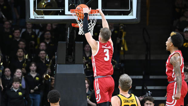 Wisconsin guard Connor Essegian dunking the basketball against Iowa in overtime.
