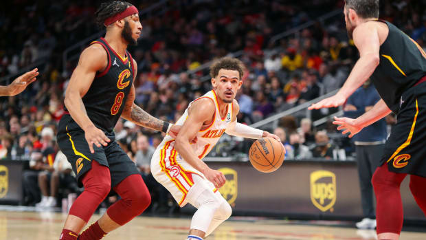 Mar 31, 2022; Atlanta, Georgia, USA; Atlanta Hawks guard Trae Young (11) is defended by Cleveland Cavaliers forward Lamar Stevens (8) in the second half at State Farm Arena.
