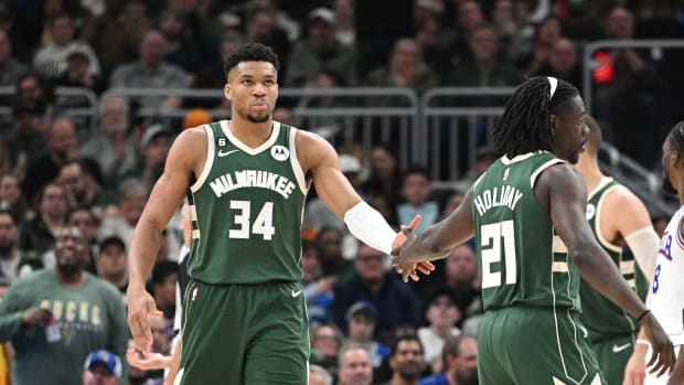 Mar 4, 2023; Milwaukee, Wisconsin, USA; Milwaukee Bucks forward Giannis Antetokounmpo (34) is congratulated by Milwaukee Bucks guard Jrue Holiday (21) after making a basket and being fouled on the play against Philadelphia 76ers in the second half at Fiserv Forum.