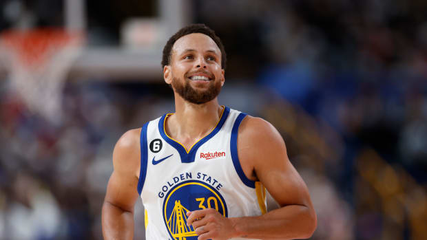 Stephen Curry smiles after a made shot.