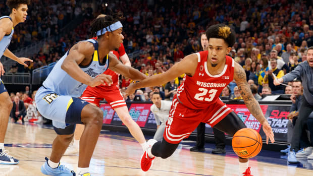Wisconsin guard Chucky Hepburn dribbling the basketball against Marquette.