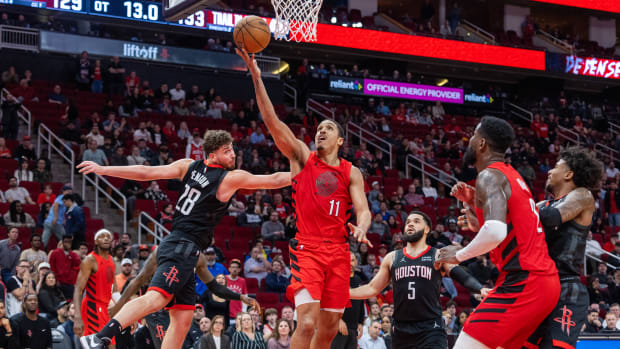 Trail Blazers guard Malcolm Brogdon shoots against Houston Rockets center Alperen Sengun in overtime at Toyota Center.