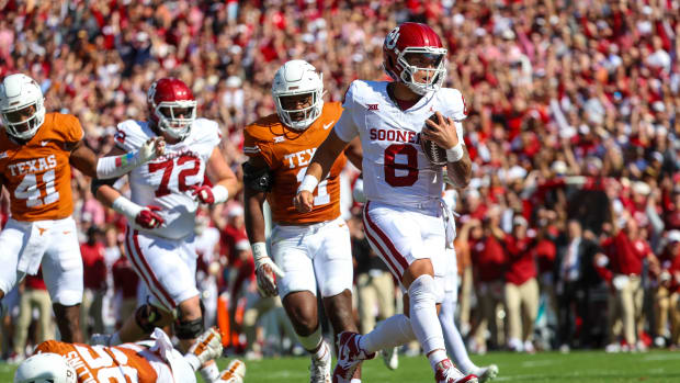 Oklahoma Sooners quarterback Dillon Gabriel (No. 8) walks into the end zone for a touchdown against the Texas Longhorns defense during the first quarter of the Red River Showdown. 
