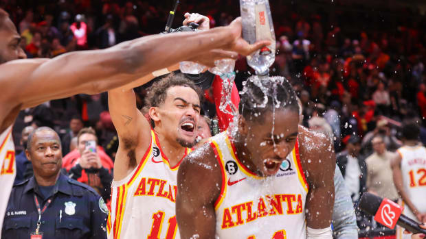 Hawks guard Trae Young dumps water on forward AJ Griffin.