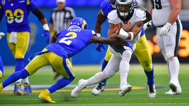 Philadelphia Eagles quarterback Jalen Hurts (1) runs the ball against Los Angeles Rams safety Russ Yeast (2) during the first half at SoFi Stadium.