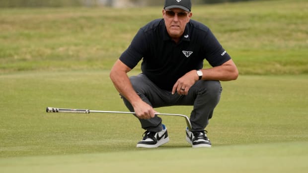 Phil Mickelson lines up a putt during the U.S. Open golf tournament.