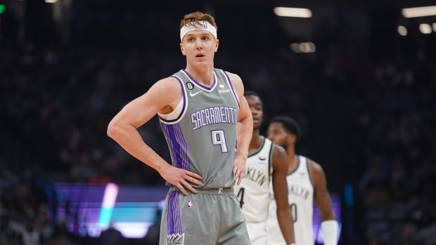 Kings guard Kevin Huerter stands on the court during a timeout.