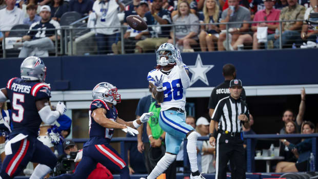 Oct 1, 2023; Arlington, Texas, USA; Dallas Cowboys wide receiver CeeDee Lamb (88) catches a touchdown pass over New England Patriots cornerback Myles Bryant (27) during the first quarter at AT&T Stadium. Mandatory Credit: Kevin Jairaj-USA TODAY Sports