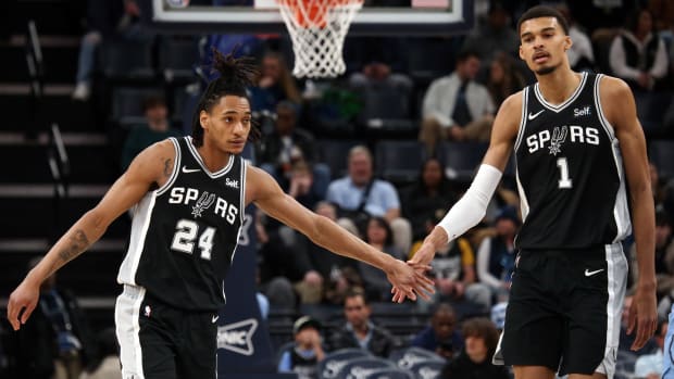 Jan 2, 2024; Memphis, Tennessee, USA; San Antonio Spurs guard Devin Vassell (24) reacts with center Victor Wembanyama (1) during the second half against the Memphis Grizzlies at FedEx Forum.