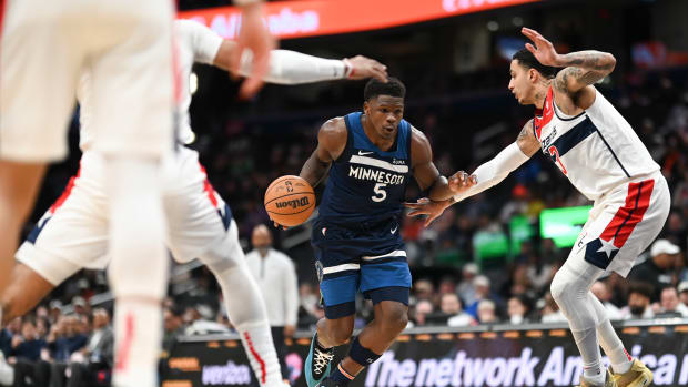 Minnesota Timberwolves guard Anthony Edwards (5) makes a move to the basket on Washington Wizards forward Kyle Kuzma (33) during the fist half at Capital One Arena.