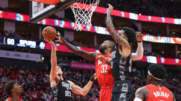 Rockets forward Jabari Smith Jr. and San Antonio Spurs forward Keldon Johnson (3) attempt to get a loose ball during the fourth quarter at Toyota Center.