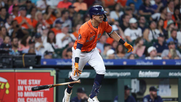 Jul 7, 2023; Houston, Texas, USA; Houston Astros second baseman Mauricio Dubon (14) hits a single during the third inning against the Seattle Mariners at Minute Maid Park. Mandatory Credit: Troy Taormina-USA TODAY Sports
